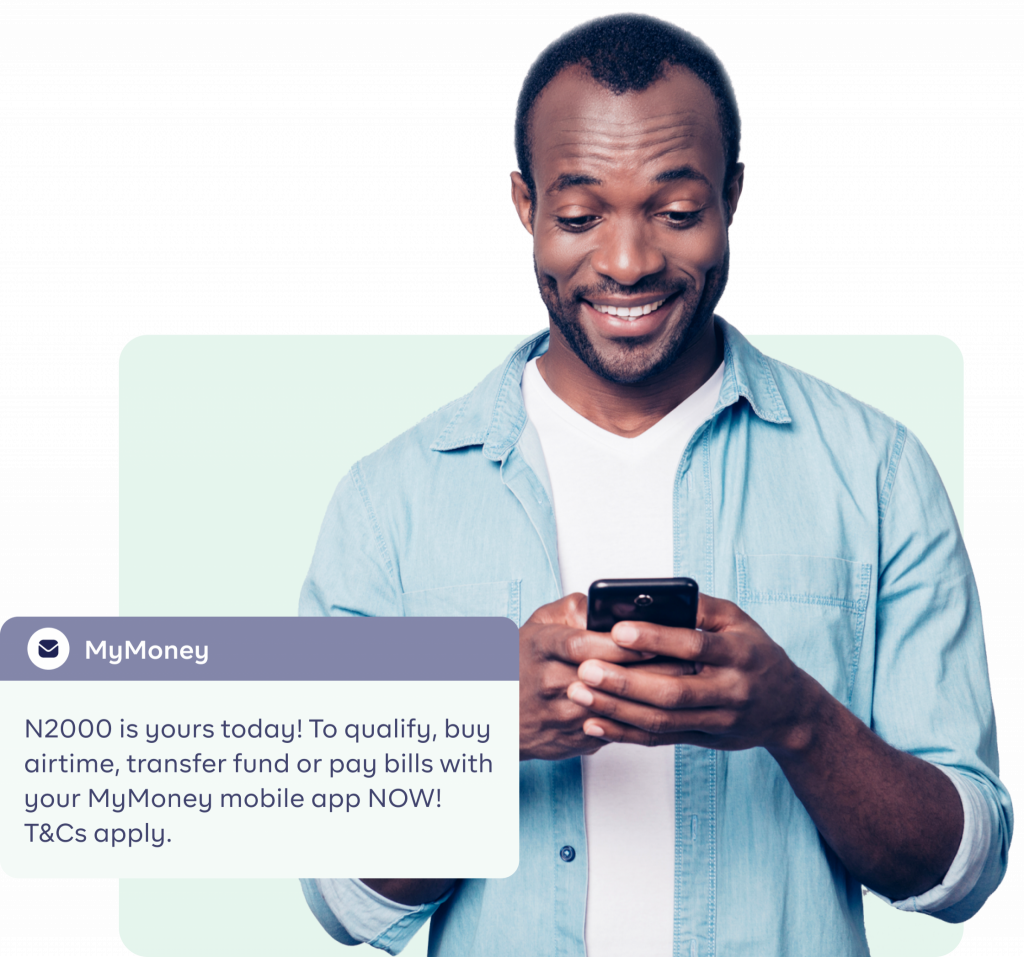 An image of a Black man pressing his phone and smiling